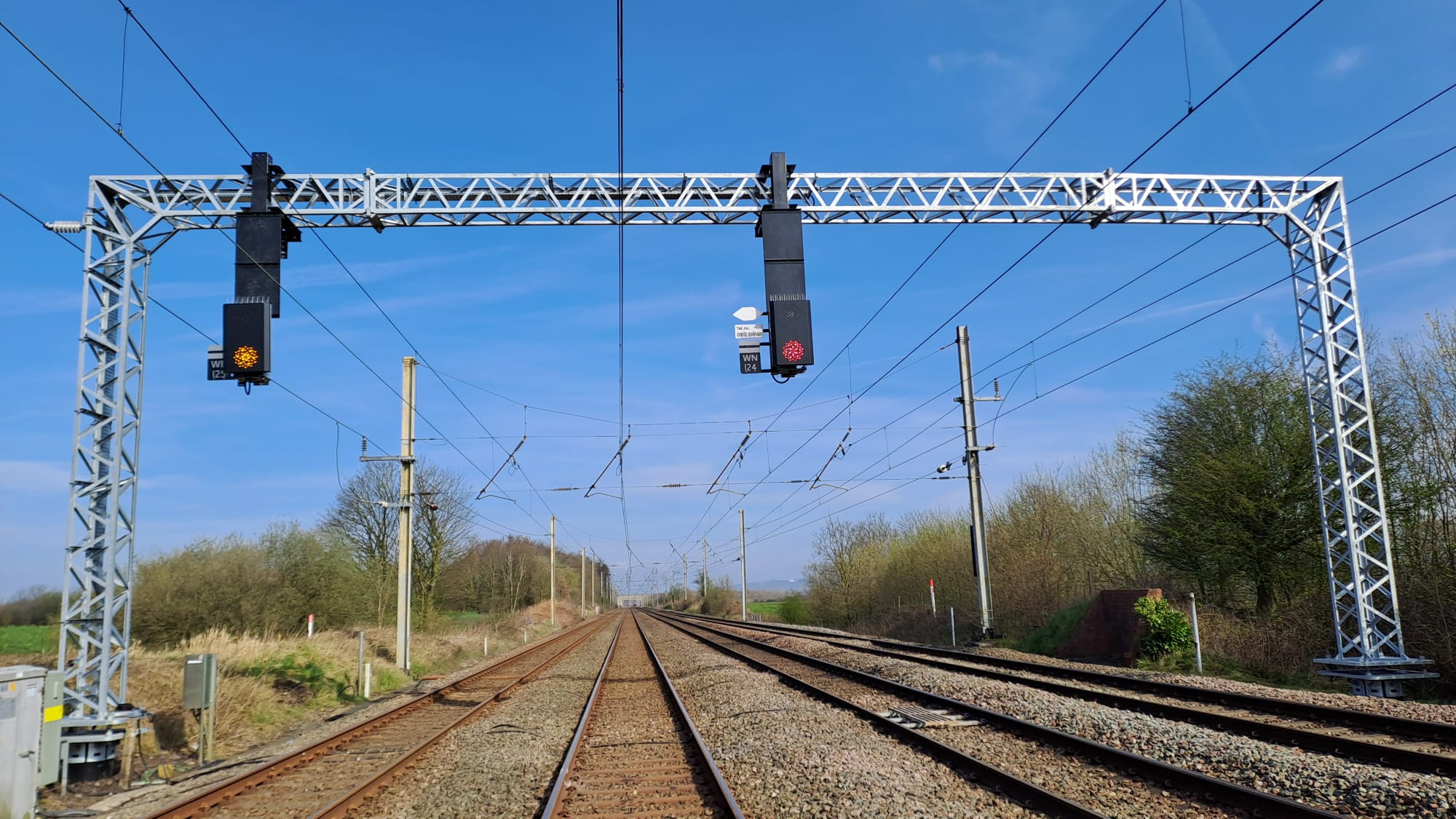 Gantry with rail signals on a sunny day